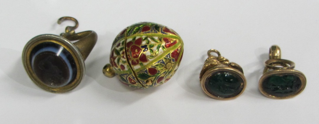 Appraisal: A gold and enameled pendant locket of shaped oval form