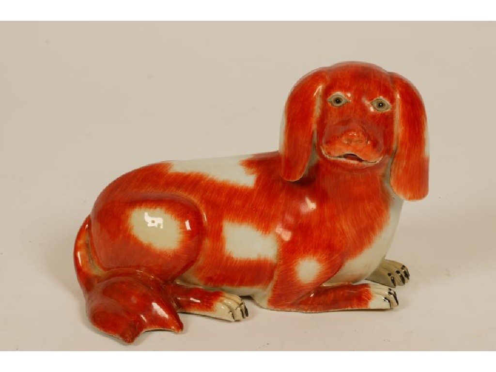 Appraisal: A CHINESE EXPORT RECUMBENT HOUND with reddish brown markings Qianlong