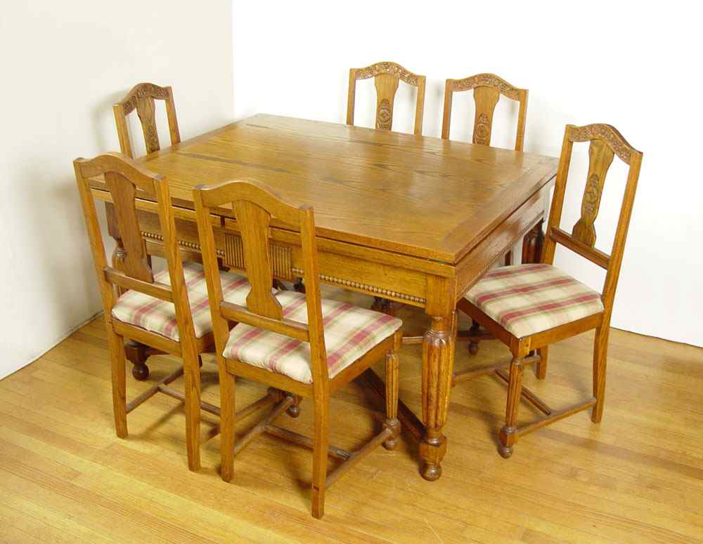 Appraisal: OAK DRAW LEAF DINING TABLE AND CHAIRS Expandable slide out