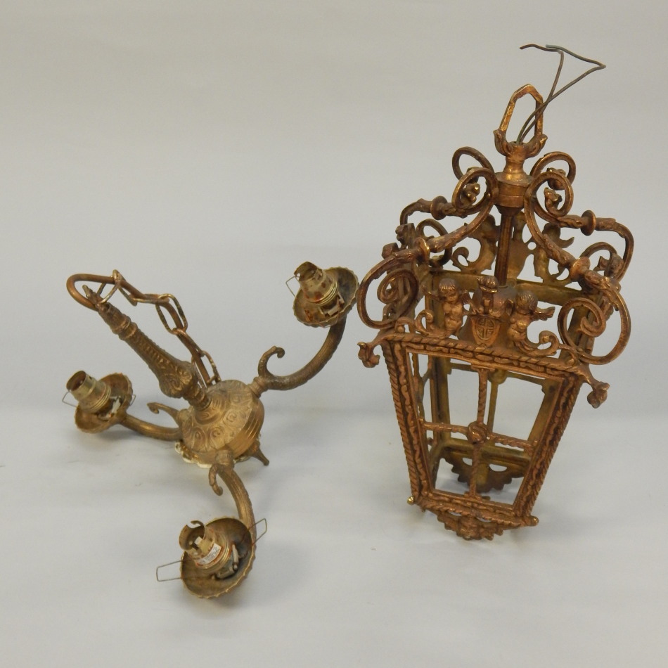 Appraisal: A Continental gilt metal ceiling lantern modelled with putti crests