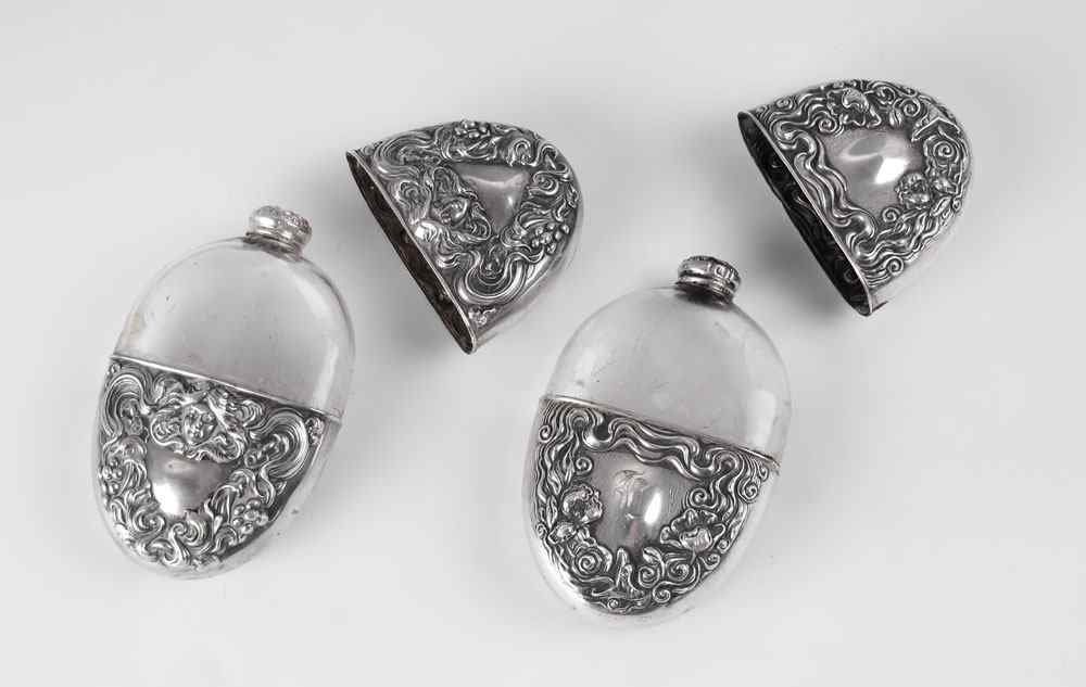 Appraisal: ART NOUVEAU STERLING FLASKS In typical art nouveau motifs one