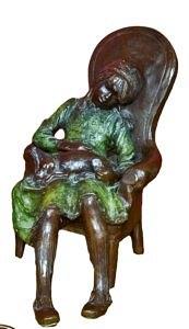 Appraisal: A bronze figure of a seated girl with a dog