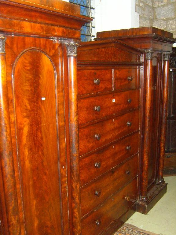 Appraisal: An early th century mahogany architectural sectional wardrobe the central