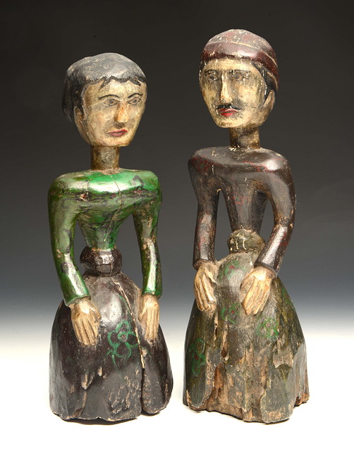 Appraisal: A PAIR OF FOLK ART CARVED WOODEN FEMALE FIGURES each