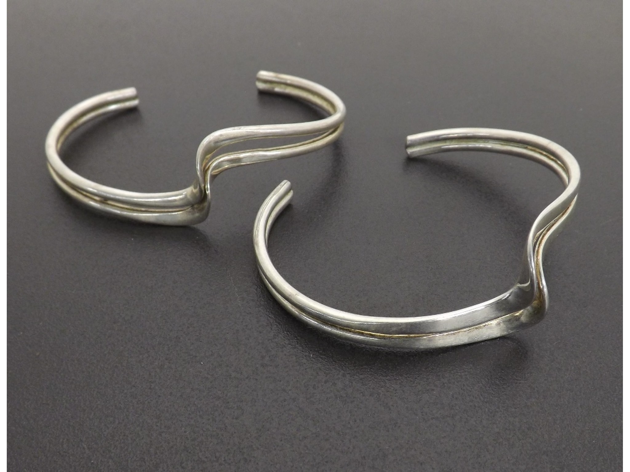 Appraisal: Two modern silver bangles