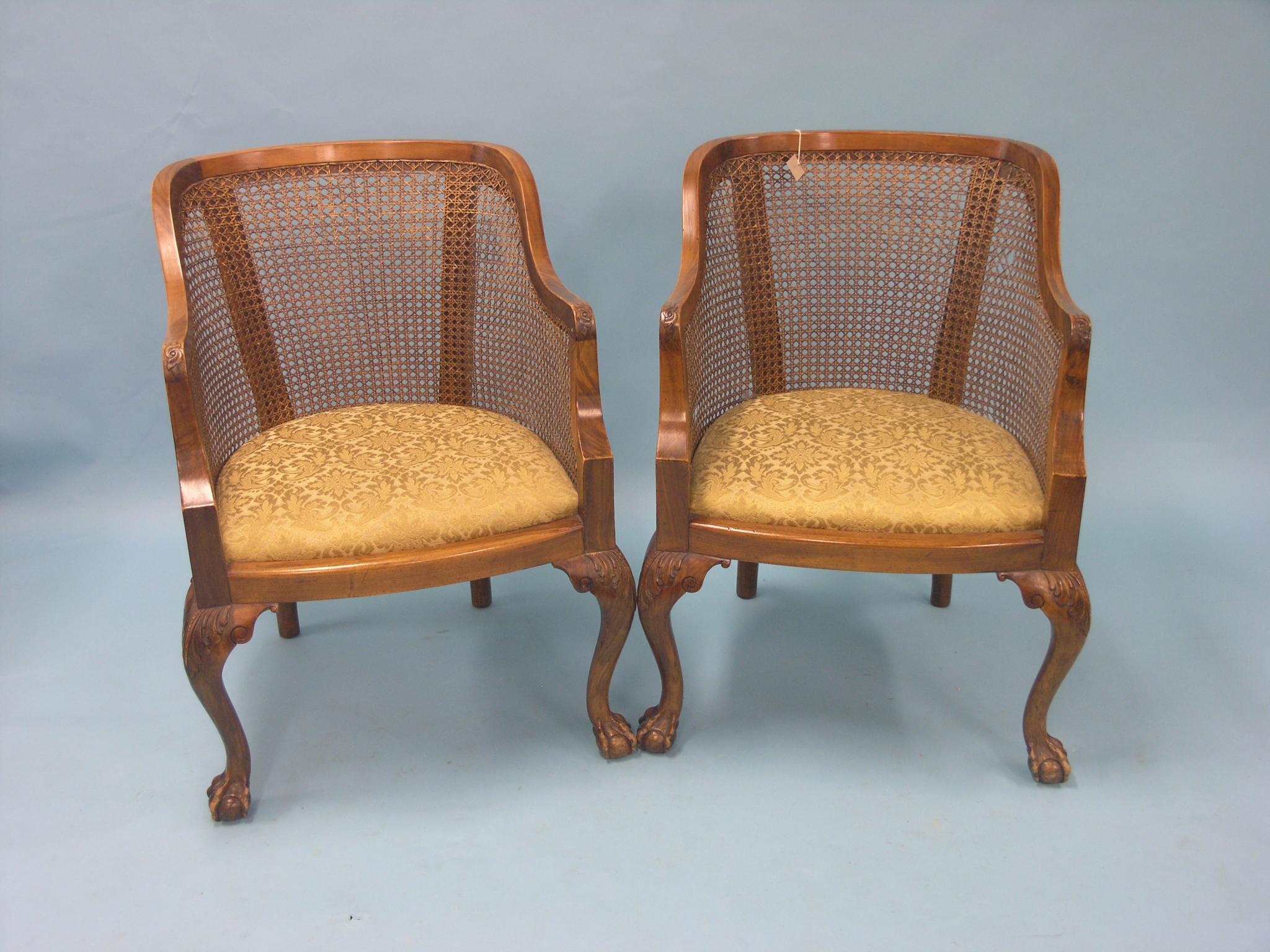 Appraisal: A pair of walnut-framed bergere elbow chairs with drop-in seats