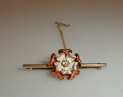 Appraisal: A bar brooch with attached Tudor rose enamelled in white