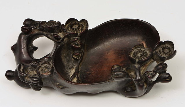 Appraisal: A CHINESE CARVED HARDWOOD BRUSH WASHER with blossom decoration and