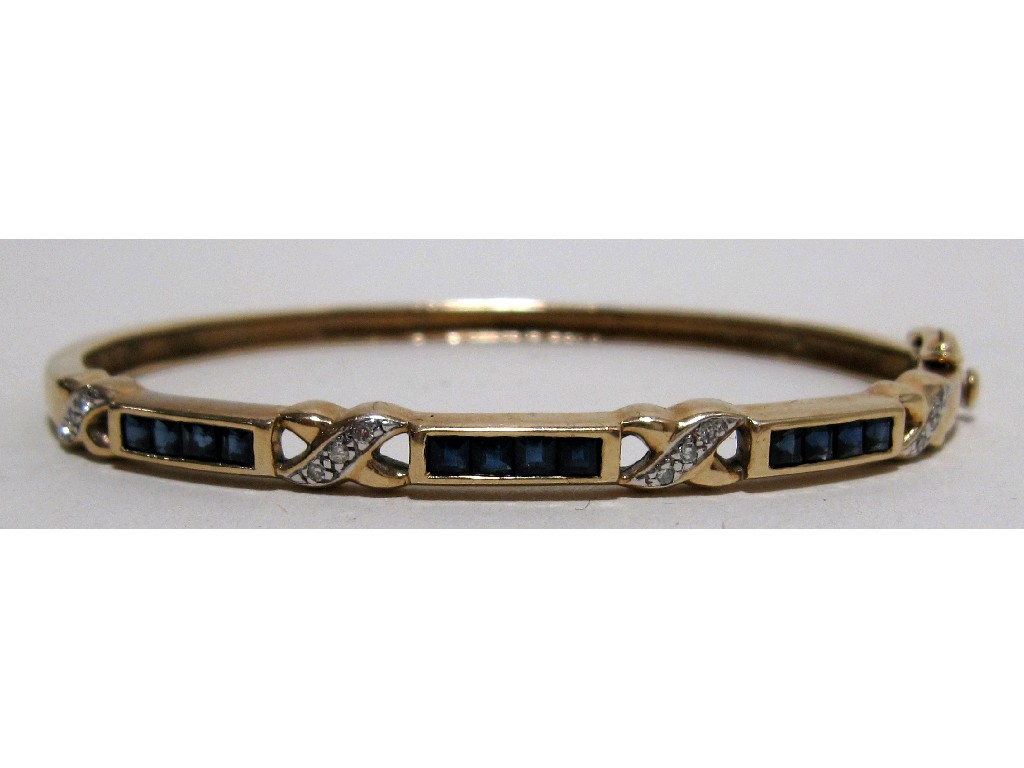 Appraisal: Nine carat gold sapphire and diamond set bangle