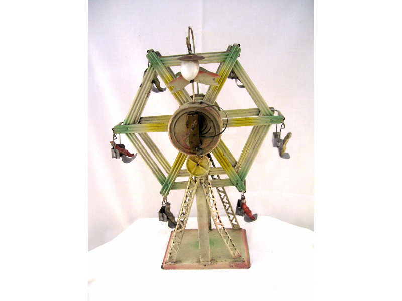 Appraisal: Clockwork Ferris Wheel Tin construction with chalk-like figures Keywind stripped