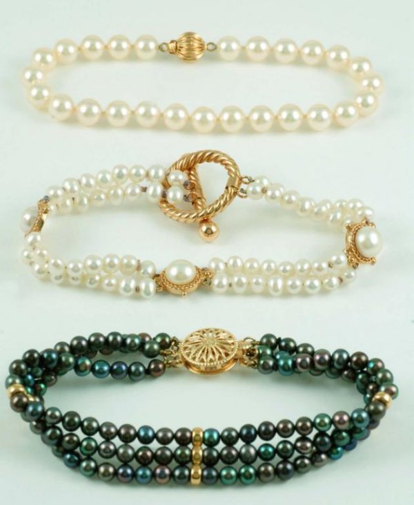 Appraisal: Three pearl bracelets One three strand of black mm pearls