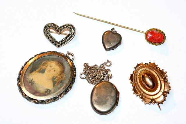 Appraisal: A CONTINENTAL OVAL LOCKET with inset miniature a gold brooch