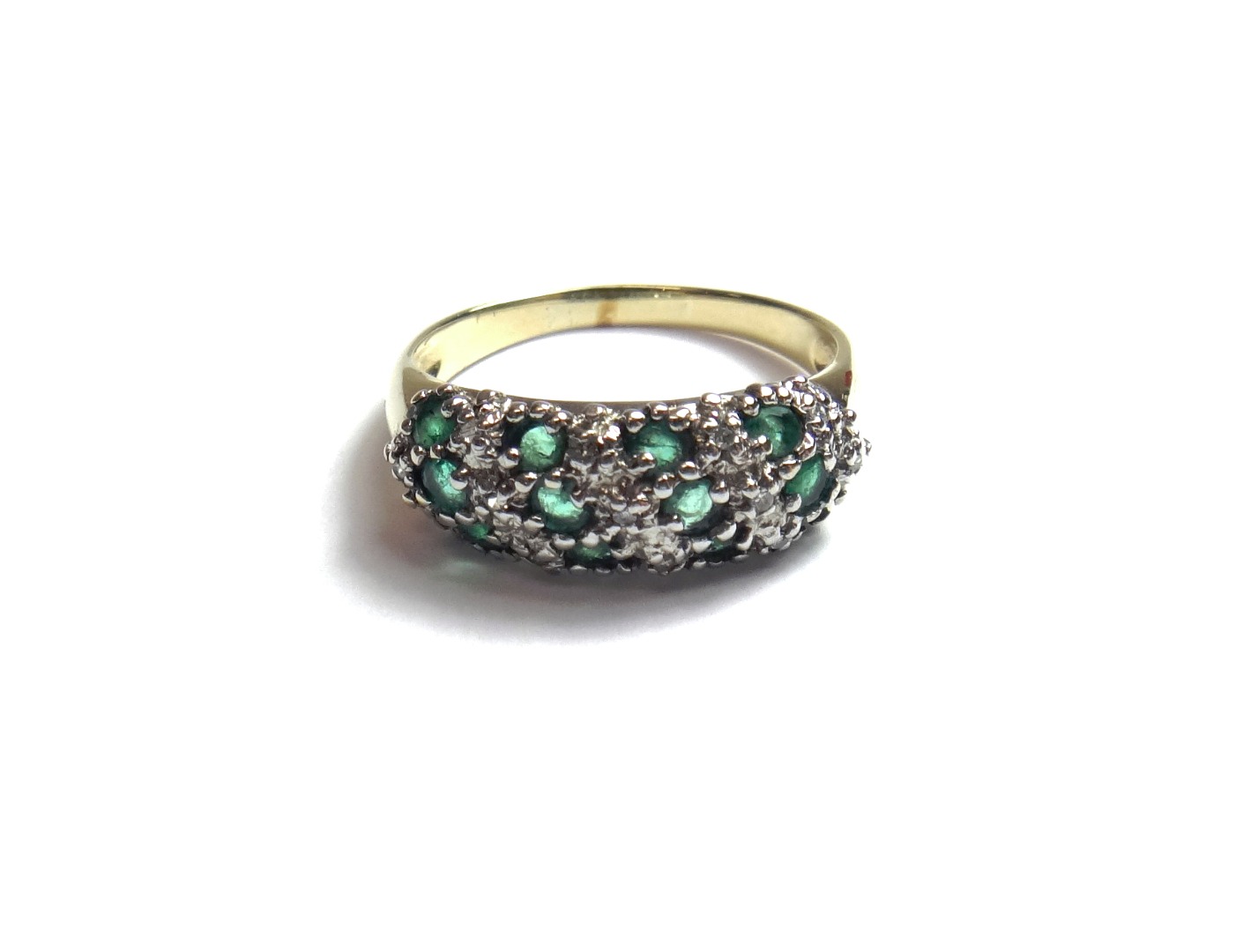 Appraisal: A gold emerald and diamond set ring mounted with four