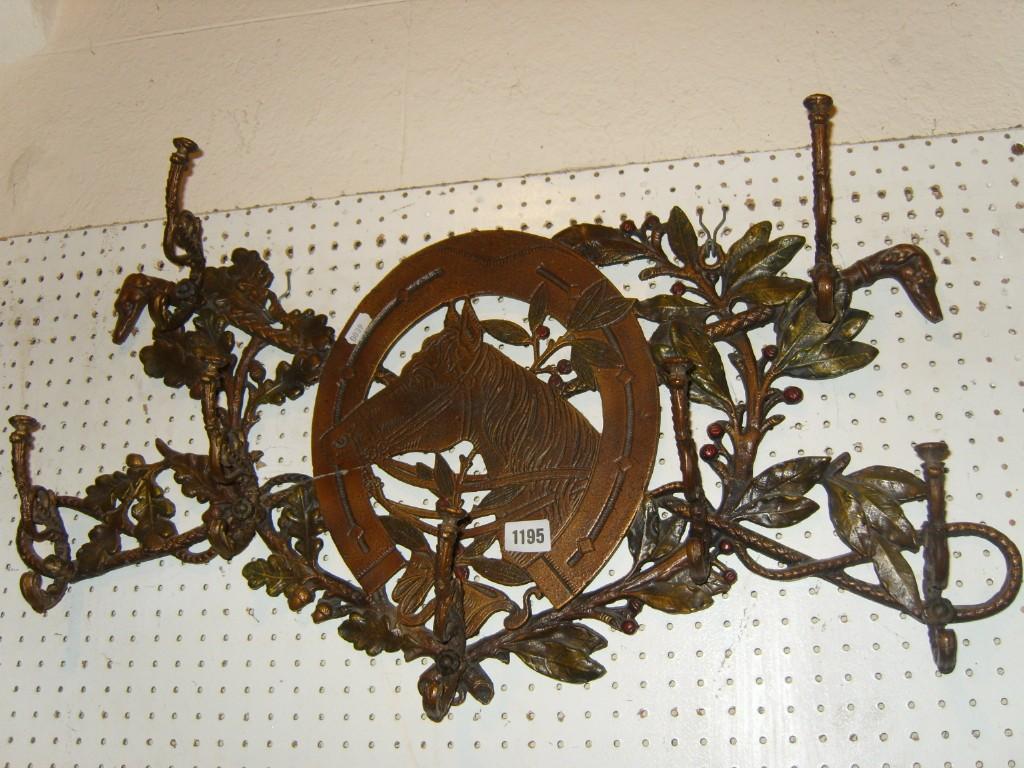 Appraisal: A decorative cast iron framed wall mounted hat coat rack