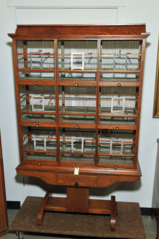 Appraisal: BIRDCAGE ON BASE Oak birdcage with nine seperate compartments rests