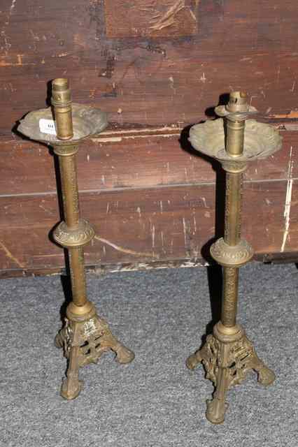 Appraisal: A PAIR OF GILT CAST TABLE LAMPS with leaf columns