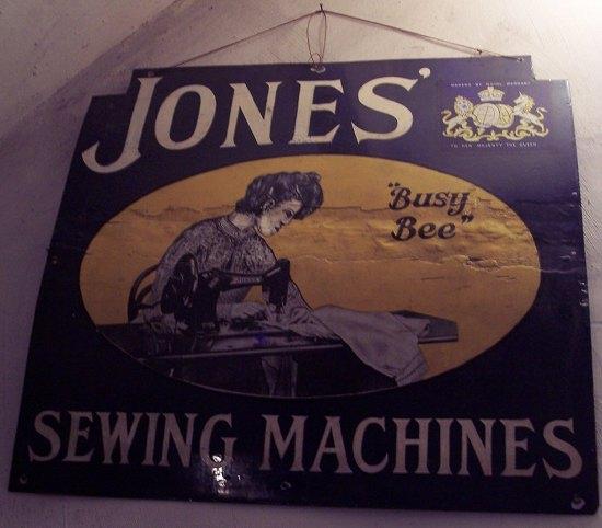 Appraisal: An enamel sign advertising Jones' Busy Bee Sewing Machines cm