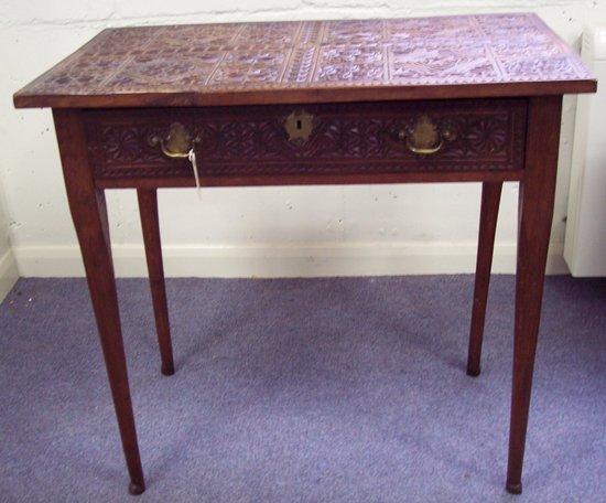 Appraisal: A carved oak side table the top with intricately carved