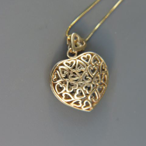 Appraisal: k Gold Sterling Silver Heart Pendant Open Windows of the