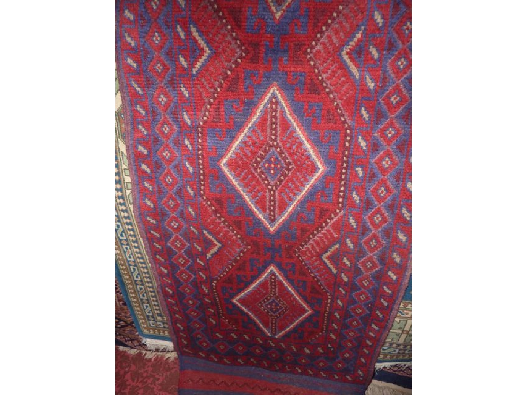 Appraisal: A wool runner with medallion centre principally in a red