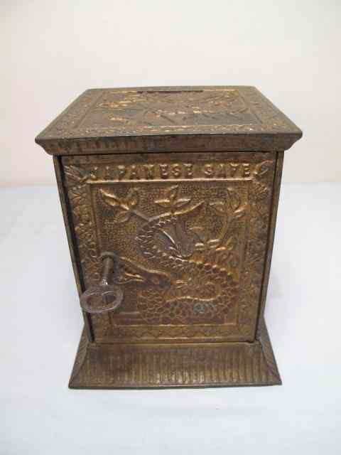 Appraisal: Chinoiserie relief decorated locking safe coin bank Gilt on white