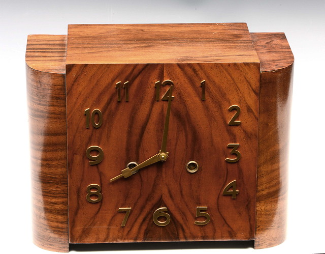 Appraisal: AN ART DECO WALNUT MANTEL CLOCK with applied polished brass