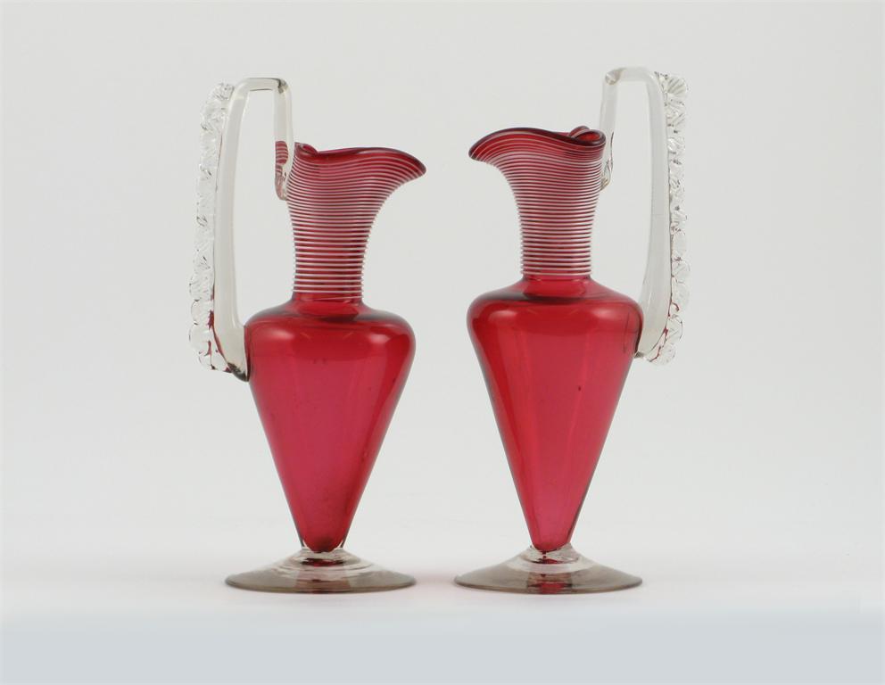 Appraisal: A pair of cranberry glass jugs