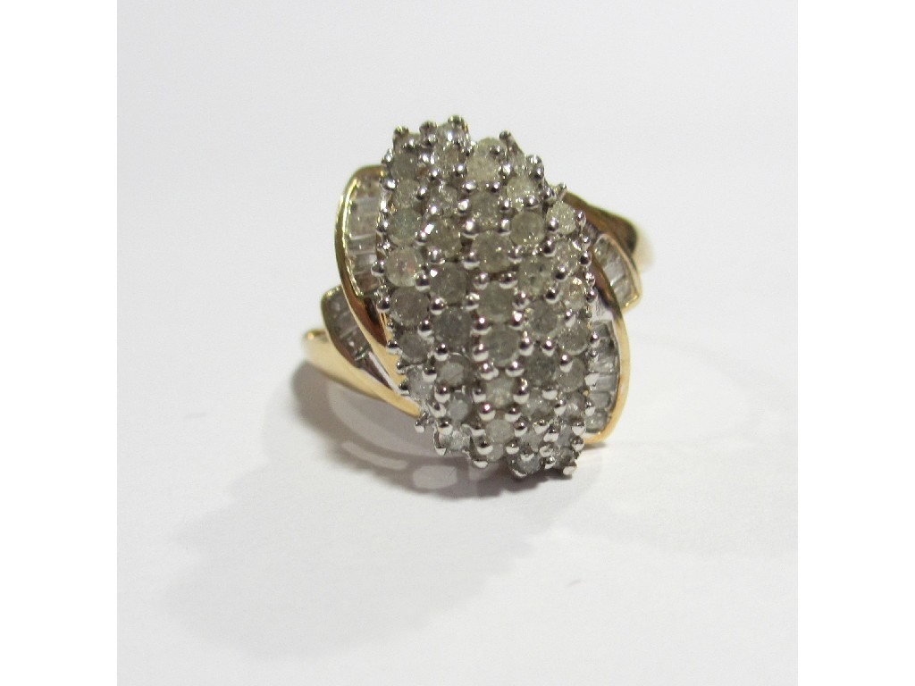 Appraisal: A nine carat gold elliptical shaped diamond cluster ring with