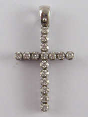 Appraisal: A white metal tests carat gold diamond set cruciform pendant