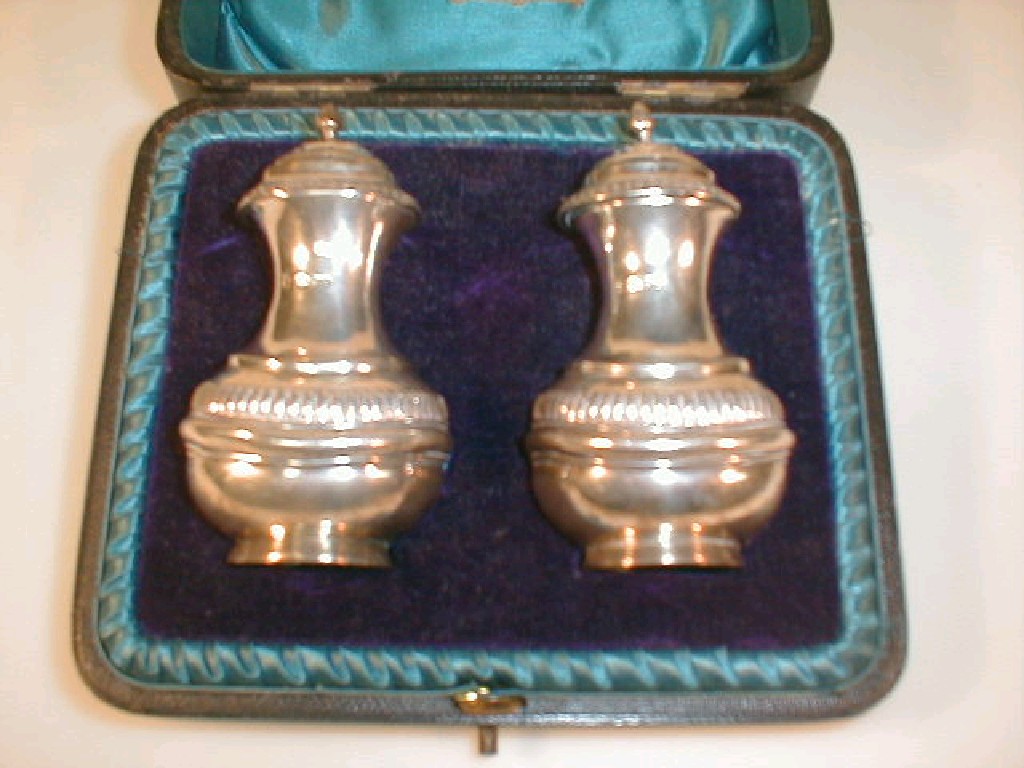 Appraisal: A pair of Edward VII silver Pepperettes retailed by Thomas