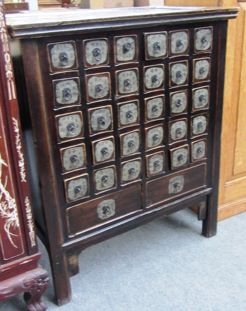 Appraisal: An early th century Chinese black lacquer thirty drawer apothecary