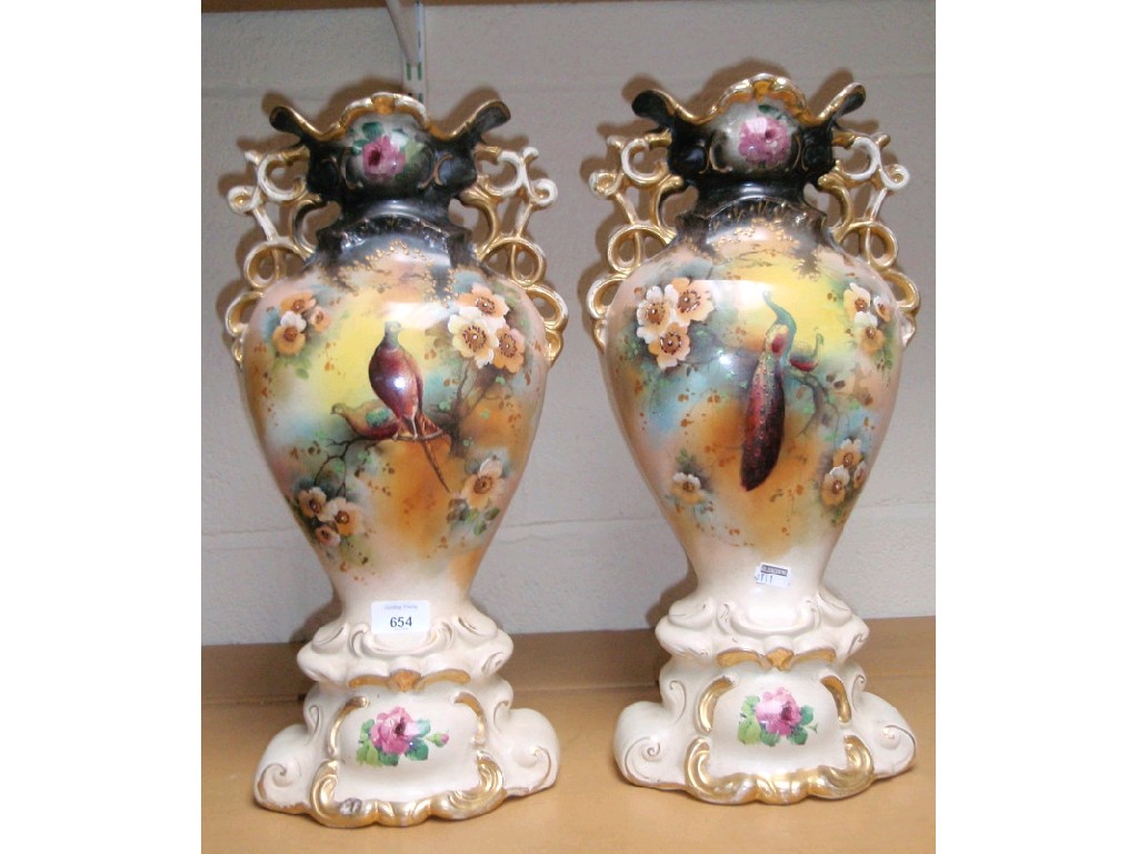 Appraisal: A pair of ornate vases with bird decoration cm high