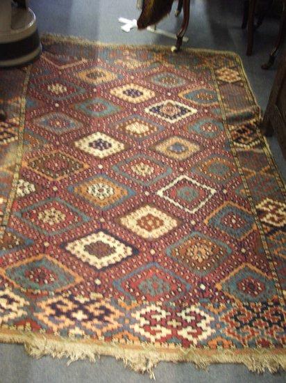 Appraisal: AN EASTERN RED GROUND RUG - decorated an all over