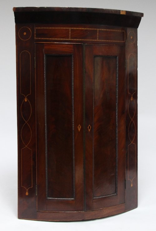 Appraisal: A late th Century mahogany bowfront corner cupboard the moulded