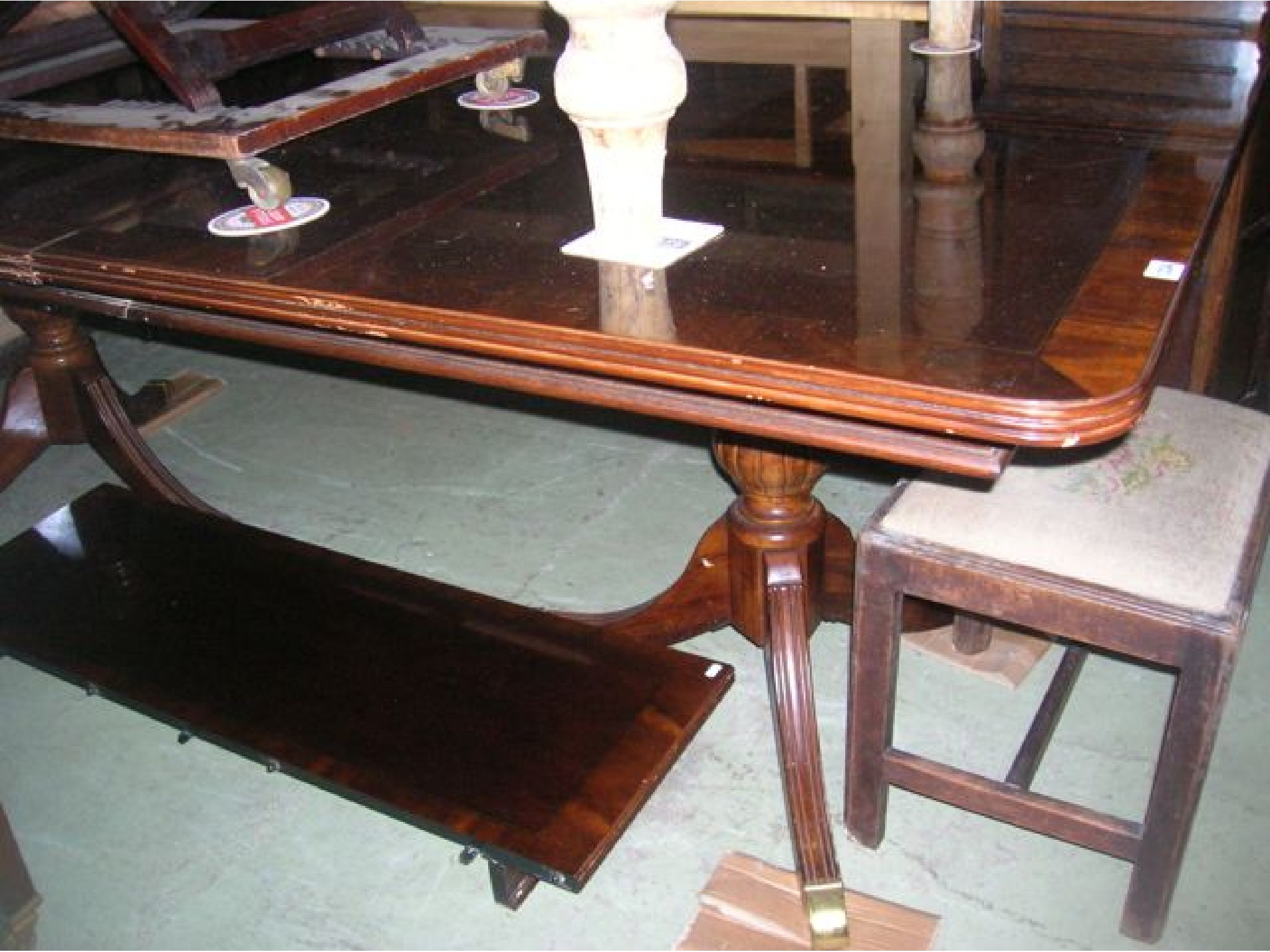 Appraisal: A reproduction mahogany twin pillar extending dining table of rectangular