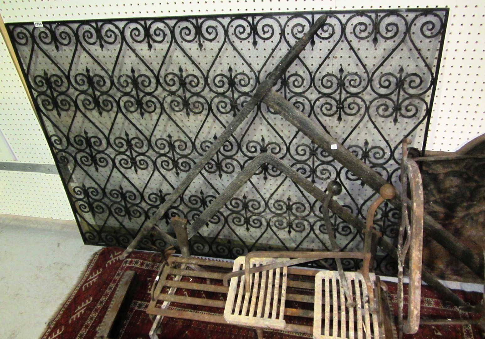 Appraisal: A group of wrought iron fire accessories a grate dogs