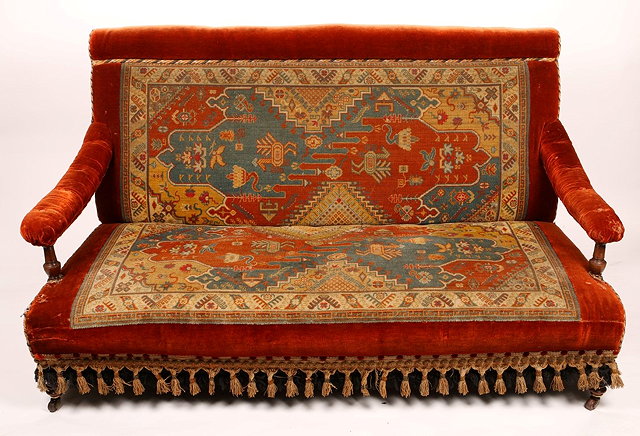 Appraisal: A LATE VICTORIAN SETTEE upholstered in Persian carpet pattern on