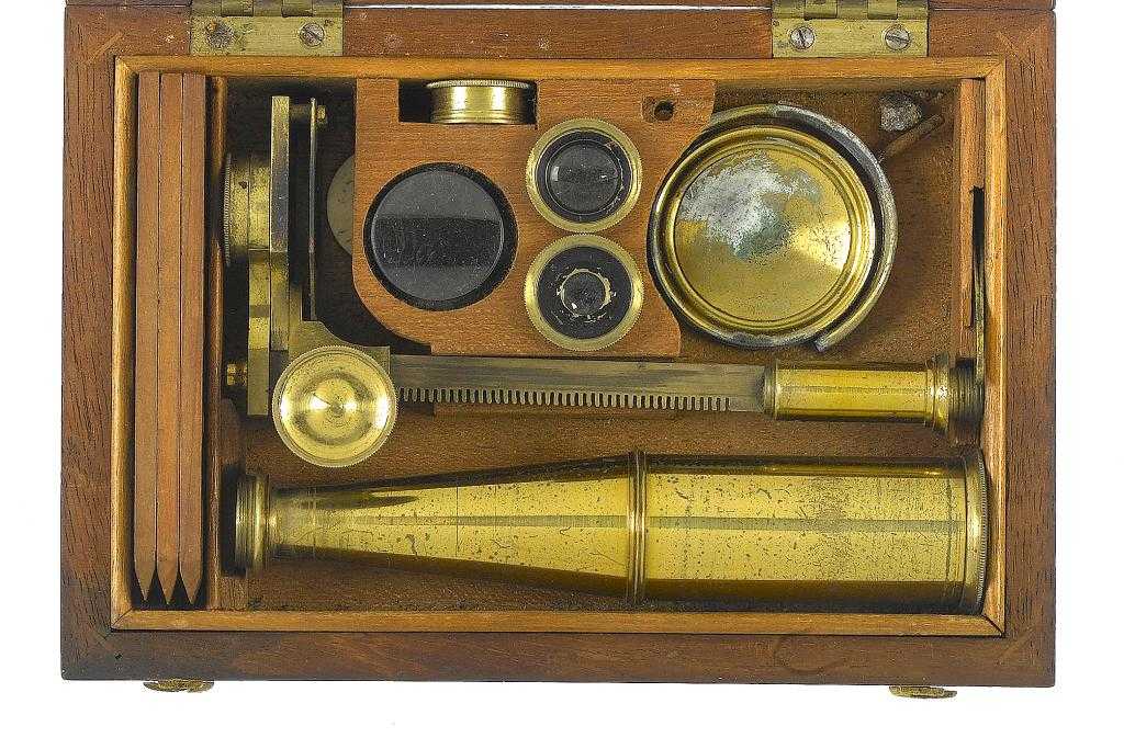 Appraisal: AN ENGLISH BRASS GOULD-TYPE COMPOUND MICROSCOPE the lid of the