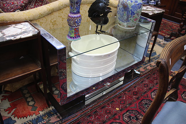 Appraisal: AN ART DECO STYLE MIRRORED CONSOLE TABLE with upright supports