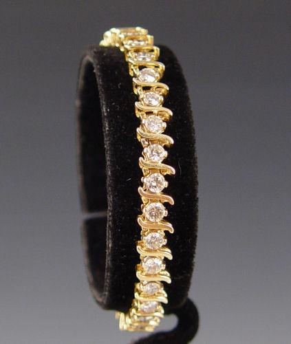 Appraisal: CT DIAMOND TENNIS BRACELET K yellow gold ''S'' link tennis