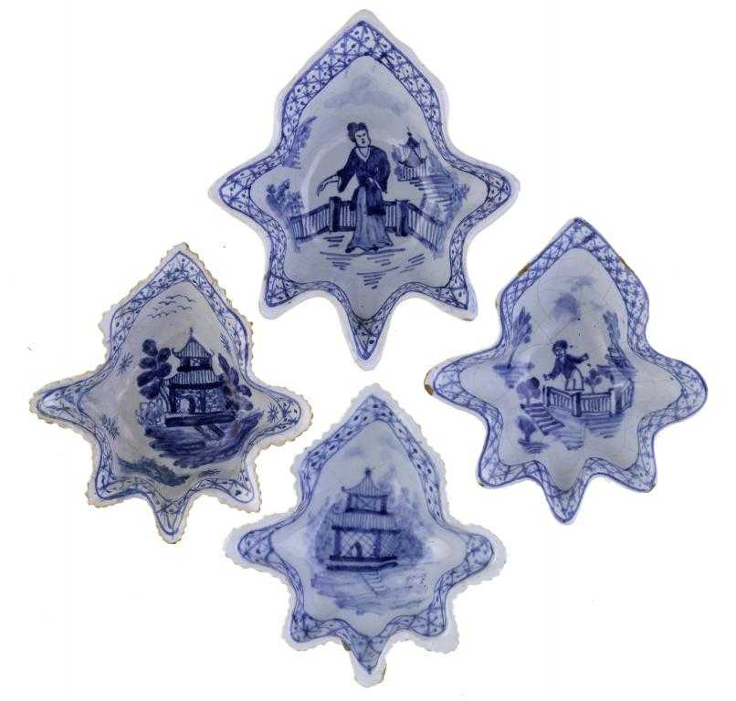 Appraisal: FOUR DUTCH DELFTWARE PICKLE DISHES of vine leaf shape painted