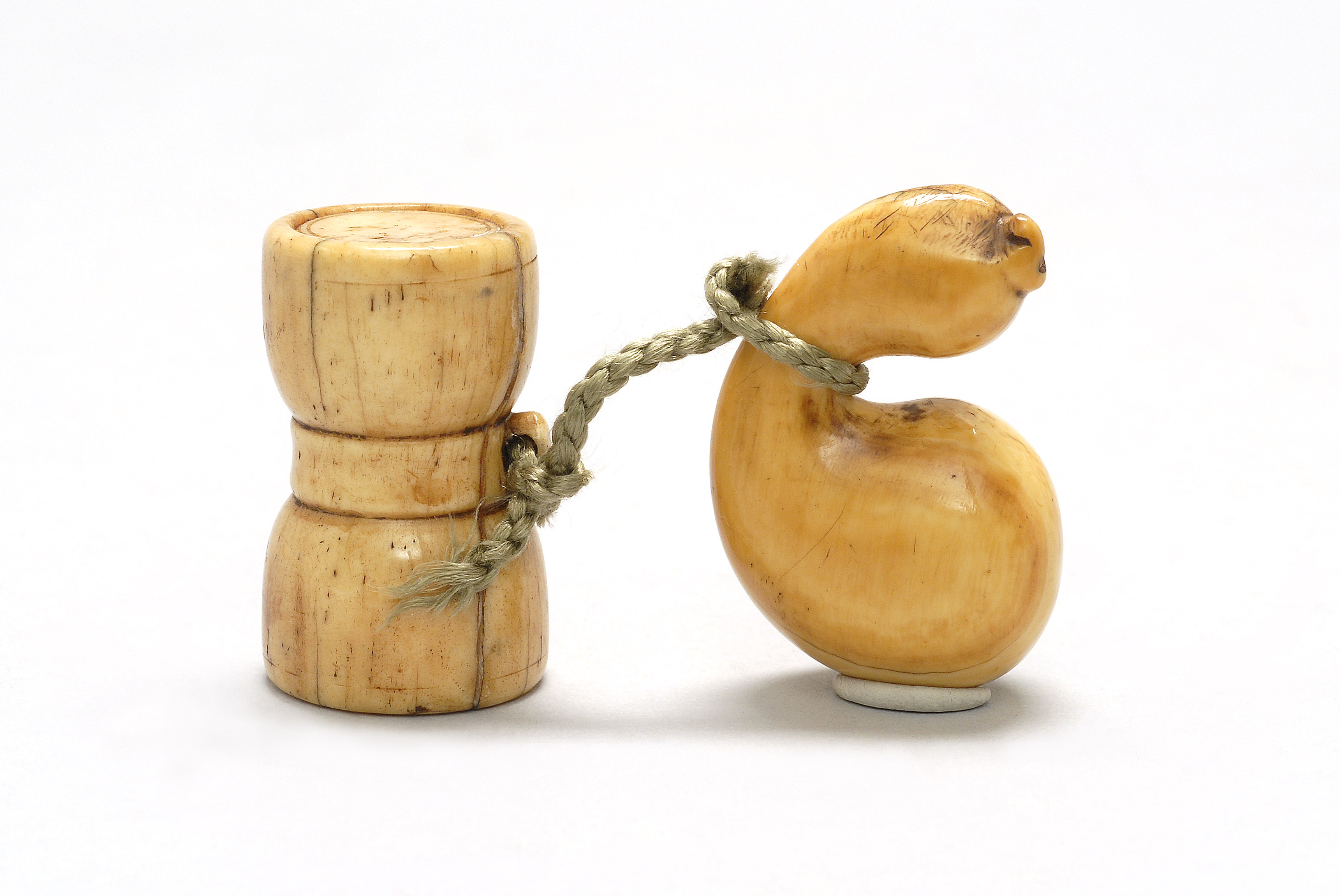 Appraisal: TWO IVORY NETSUKE th CenturyOne in gourd form and one