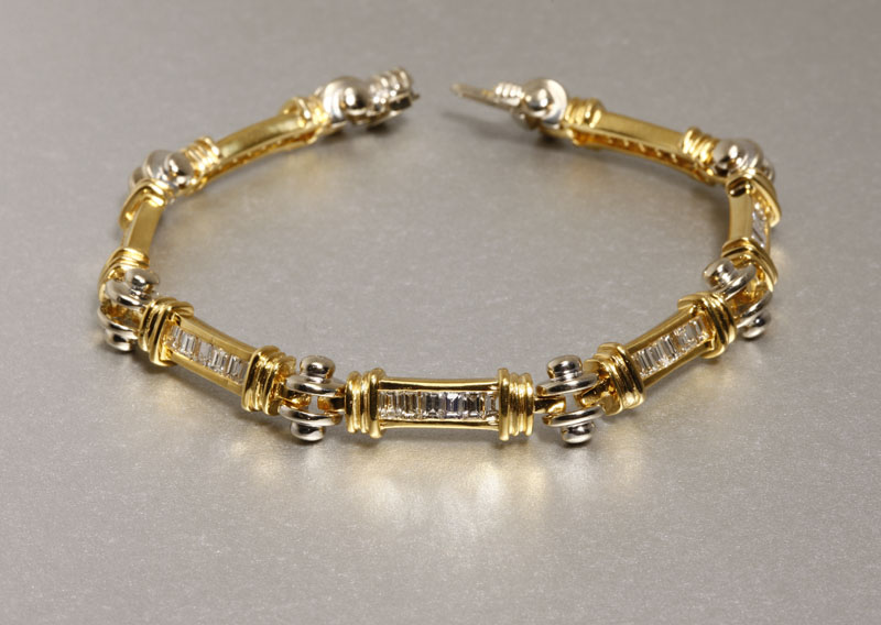 Appraisal: An K white and yellow gold channel set diamond bracelet