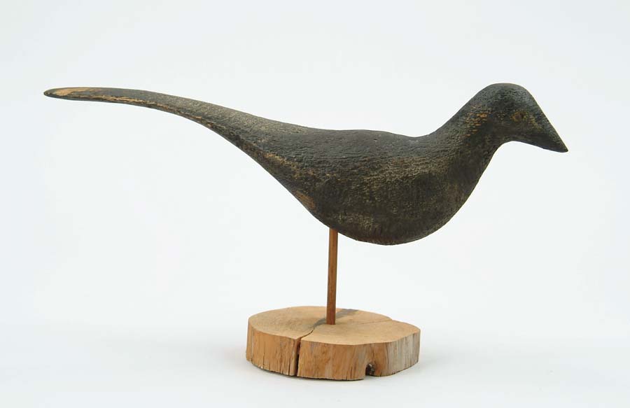 Appraisal: FOLK ART CARVED AND PAINTED BLACK BIRD Weathered surface nail