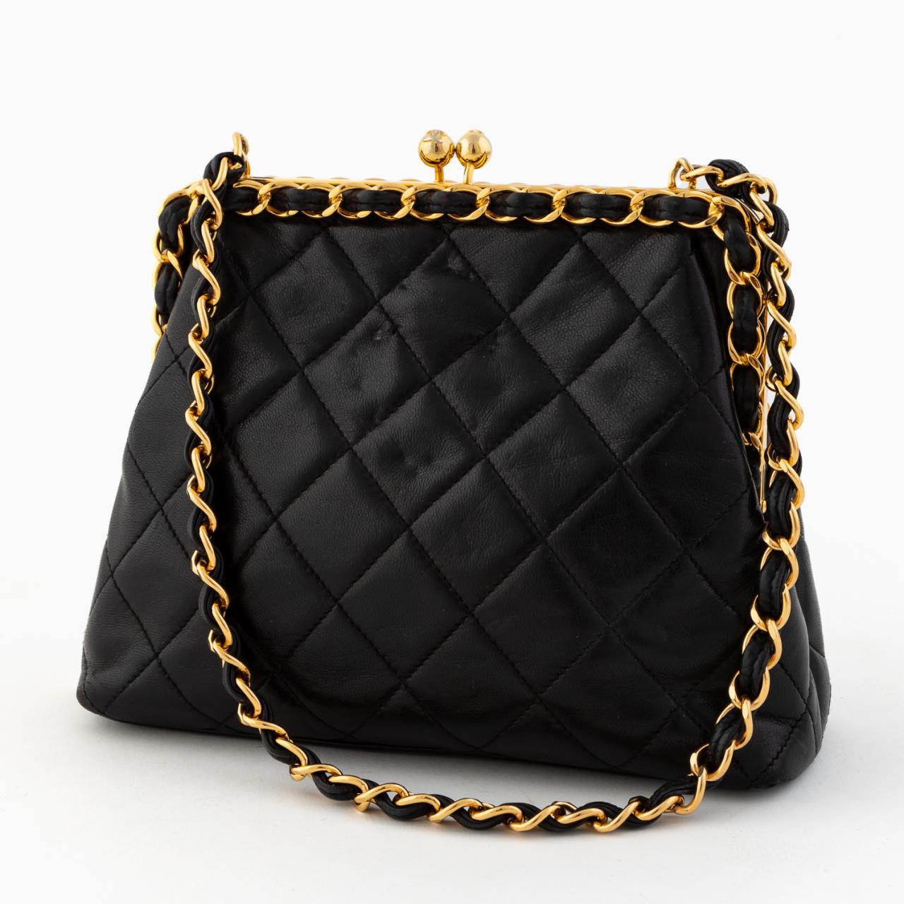 Appraisal: CHANEL BLACK LEATHER QUILTED KISS LOCK EVENING BAG Chanel French