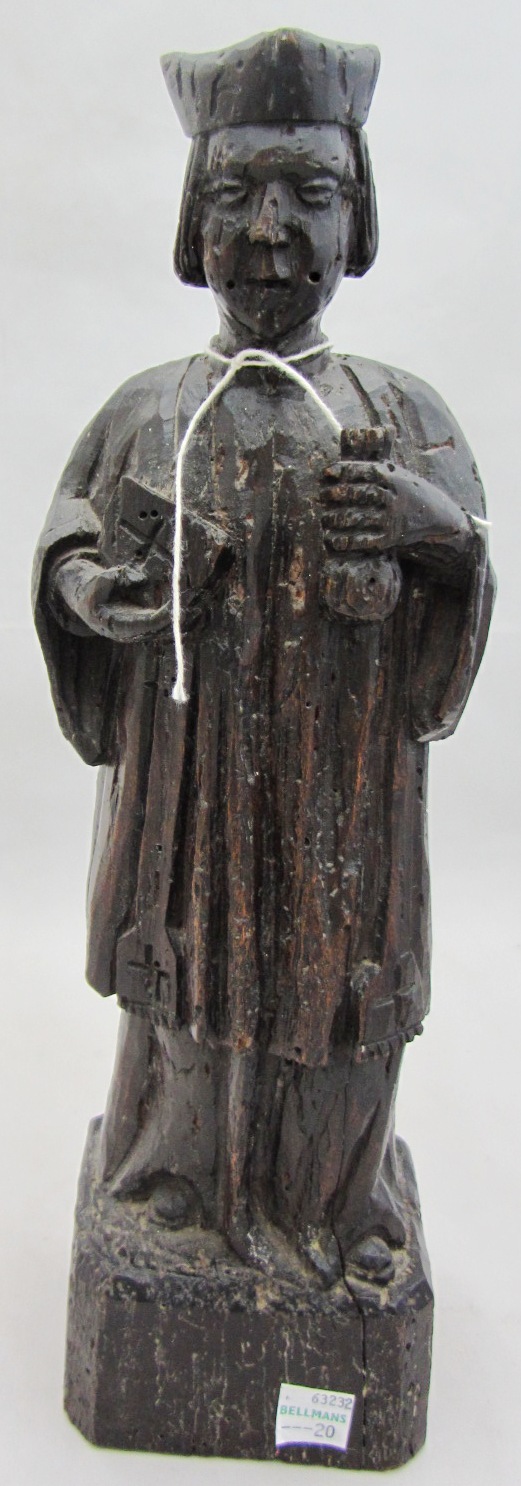 Appraisal: A th century carved oak figure of a priest modelled