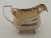 Appraisal: A George III silver barge shaped cream jug on four