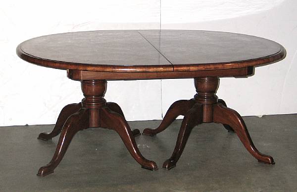 Appraisal: A George III style crossbanded walnut extension dining table with