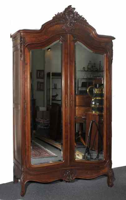 Appraisal: A LARGE TH CENTURY FRENCH ARMOIRE with a carved asymmetric