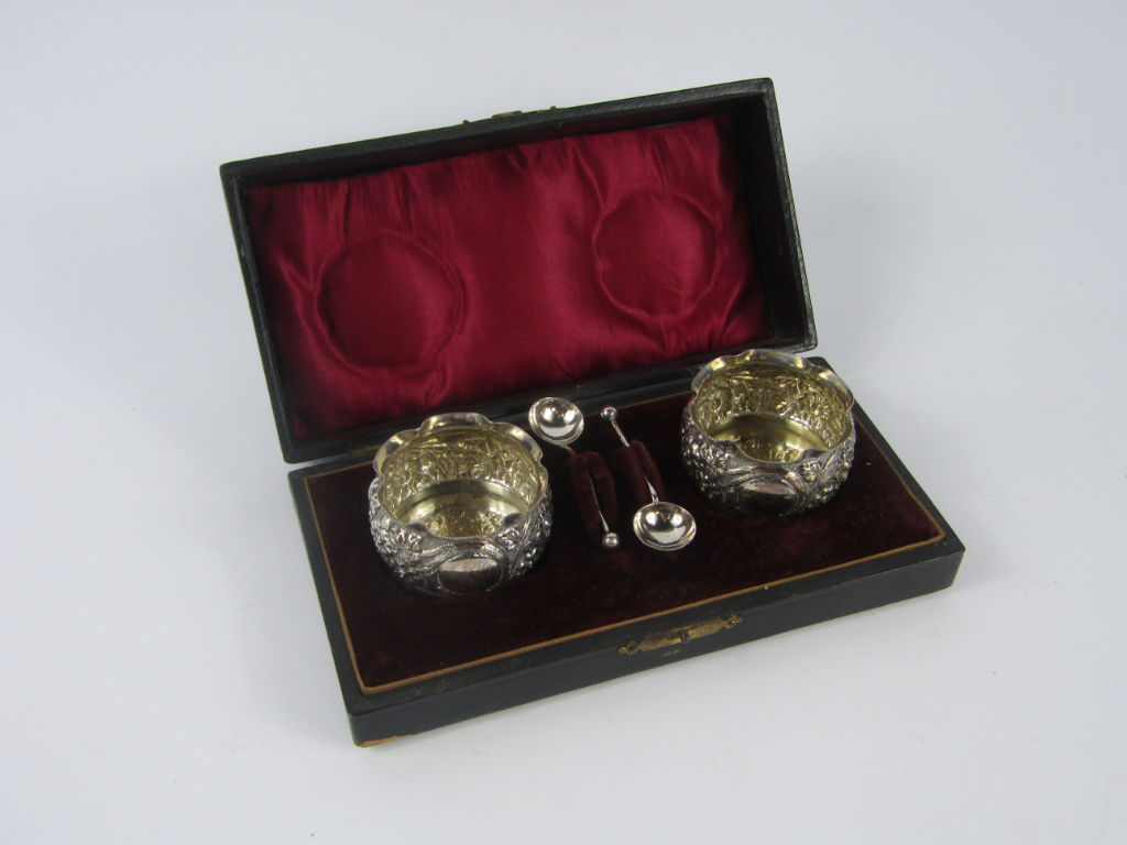 Appraisal: A pair of Victorian circular silver salts embossed with flowers